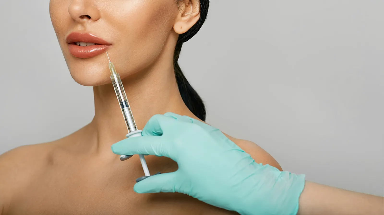 Professional applying lip filler injection — lip enhancement technique