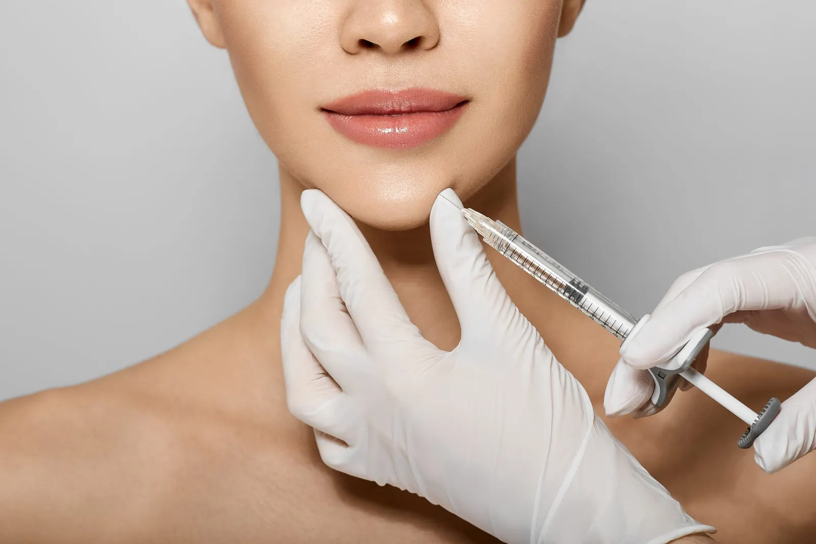 Chin injection, gloved hands